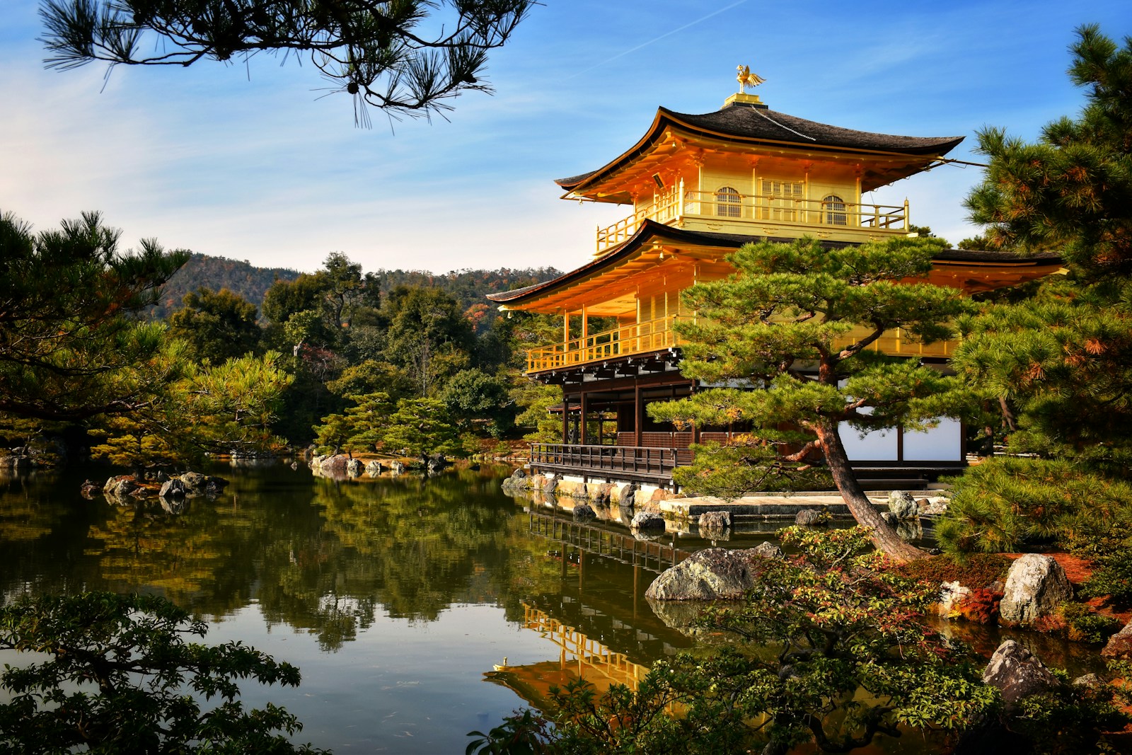 a pagoda in the middle of a lake surrounded by trees